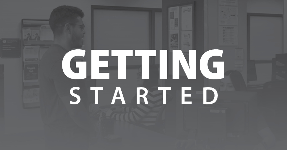 Greyscale photo of two people meeting in an office with text that reads 'Getting Started'