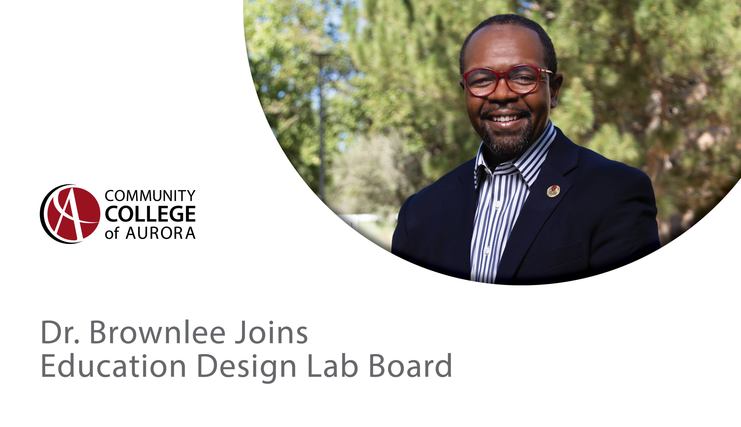 Dr. Mordecai Brownlee, President of the Community College of Aurora, smiles outdoors wearing a navy blazer, striped shirt, and red glasses. Text below reads, “Dr. Brownlee Joins Education Design Lab Board,” with the Community College of Aurora logo beneath it.