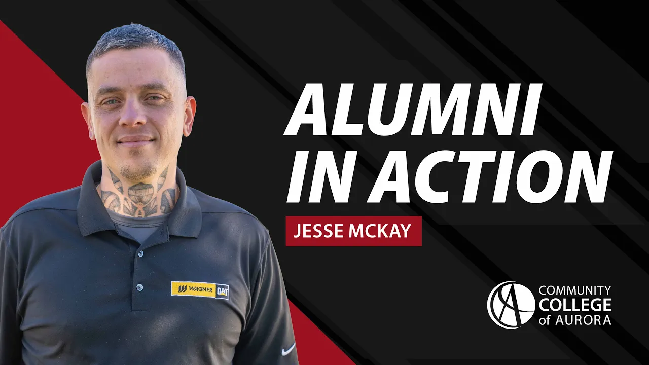 Graphic featuring a portrait of alumnus Jesse McKay standing outdoors, wearing a black polo shirt with a Wagner CAT logo. To the right, bold text reads “Alumni in Action” with “Jesse McKay” below. The Community College of Aurora logo appears in the bottom right corner on a black and red background.