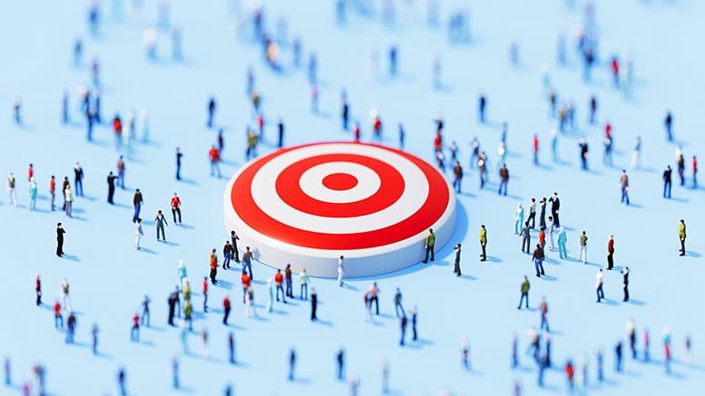 A large red and white target sits on a light blue surface, surrounded by numerous blurred, small figures. The scene conveys focus and convergence.