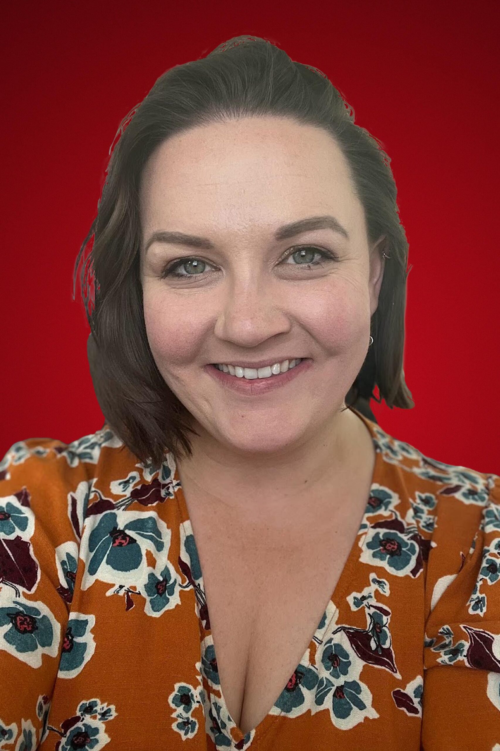 Photo of Allison Stepnitz smiling on a red background.