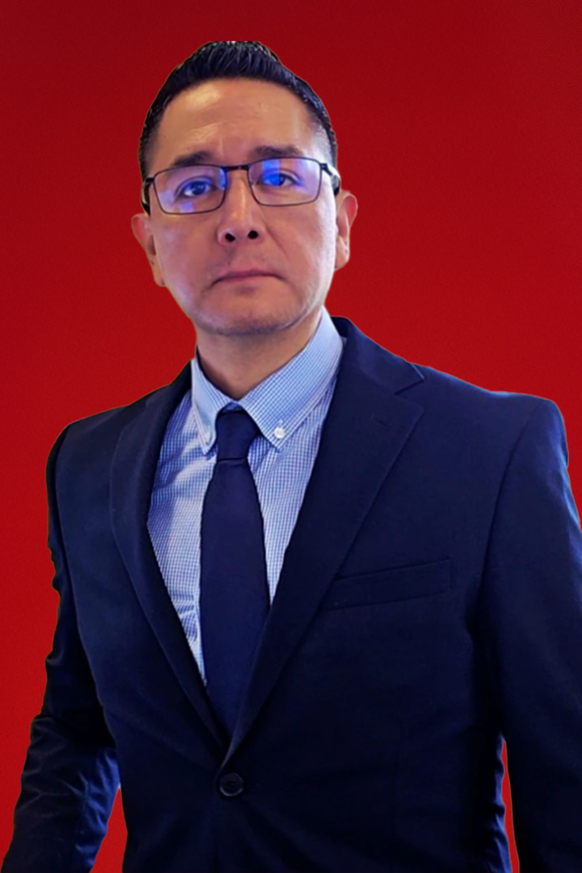Photo of Robert Vazquez in a suit on a red background.